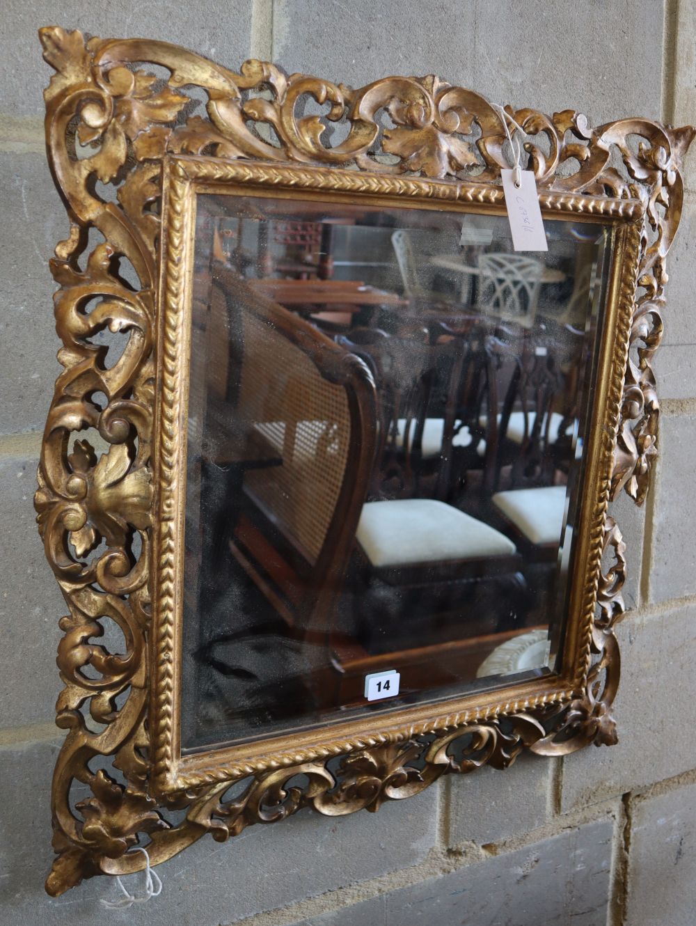 A Florentine style carved giltwood wall mirror (a.f.), W.60cm, H.66cm